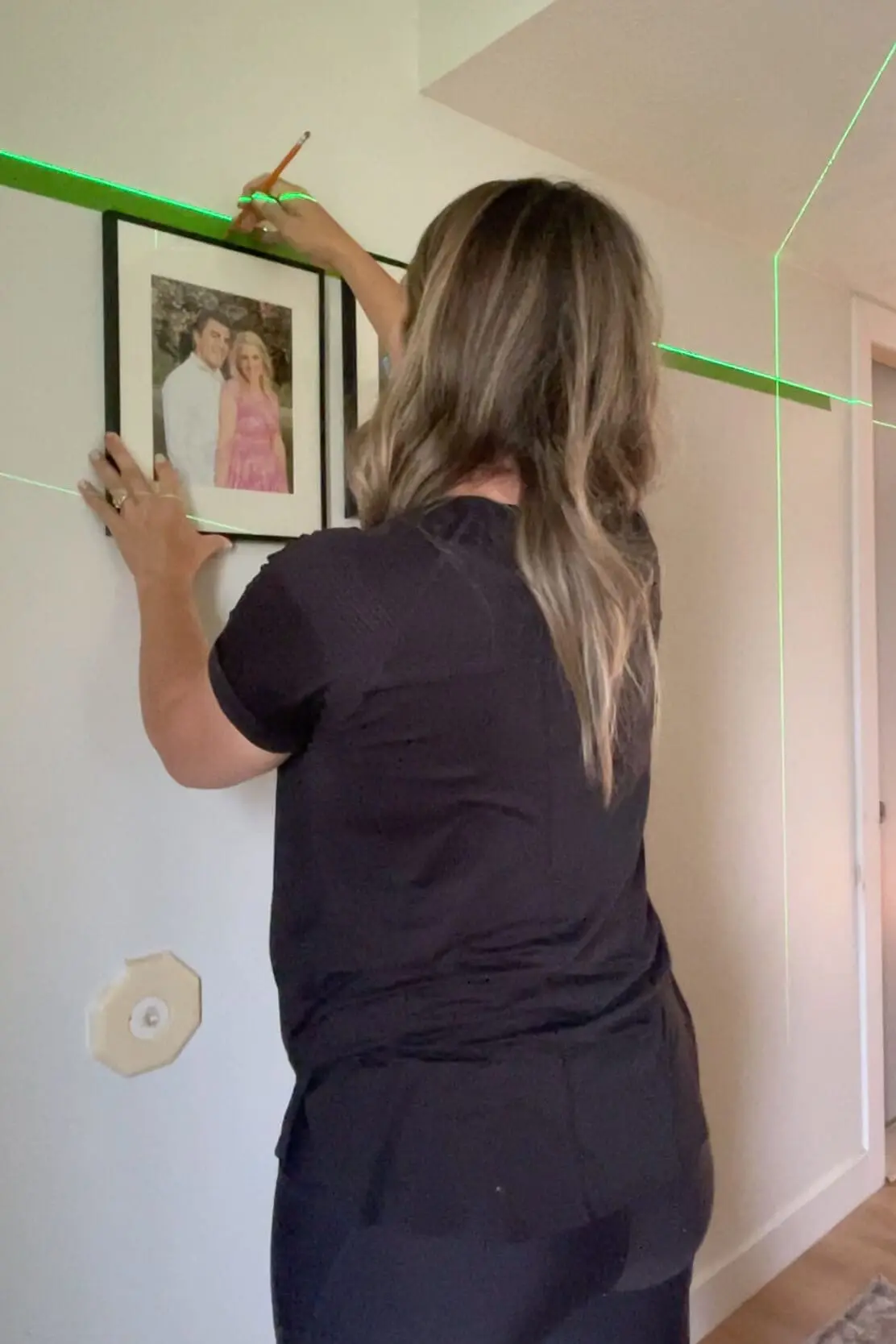 Hanging a gallery wall with family photos.